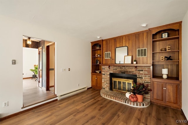 living room featuring baseboard heating, dark hardwood / wood-style floors, and a fireplace