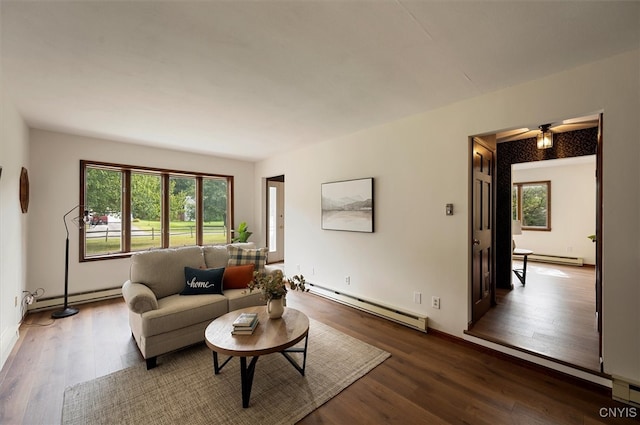 living room featuring a baseboard heating unit, ceiling fan, and dark hardwood / wood-style flooring