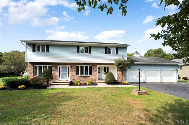 view of front of home with a front lawn and a garage