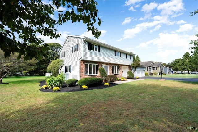 view of front facade featuring a front yard and a garage