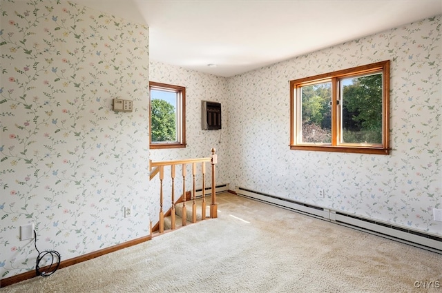 empty room featuring carpet floors, a baseboard heating unit, and a wall mounted AC