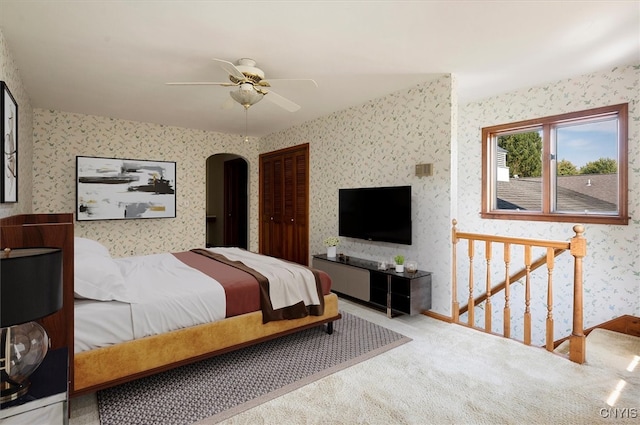 bedroom with a closet, carpet, and ceiling fan