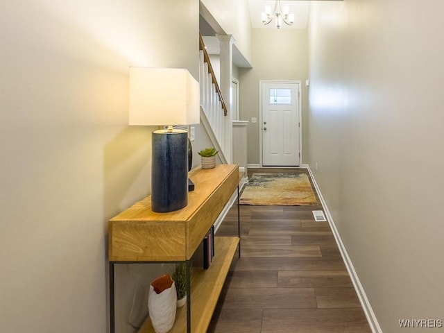 203 Carriage Ln, West Seneca, NY 14224 - doorway to outside featuring dark wood-style flooring, a chandelier, stairs, and baseboards