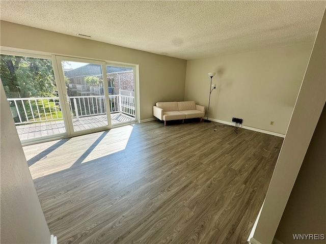 unfurnished room featuring a textured ceiling and hardwood / wood-style flooring