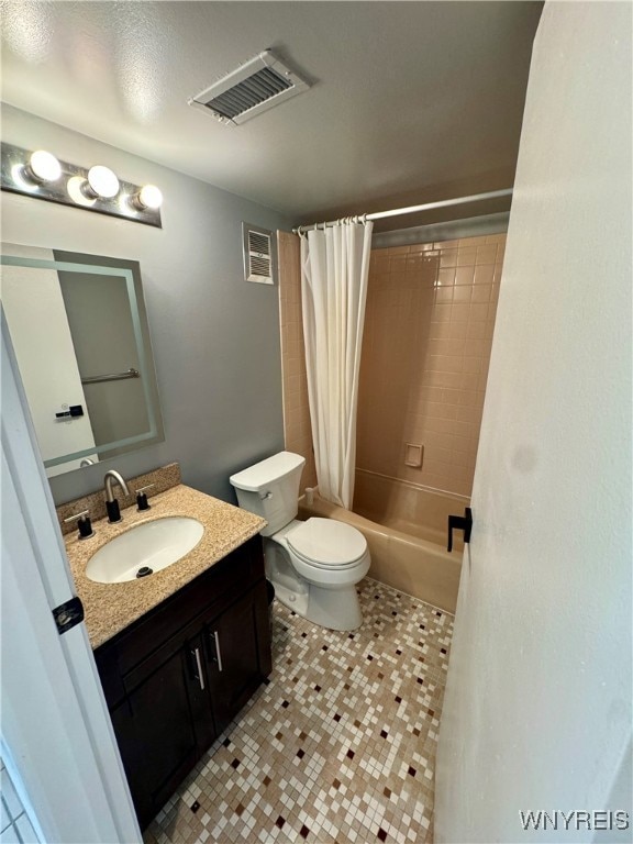 full bathroom featuring shower / bath combination with curtain, vanity, tile patterned flooring, and toilet