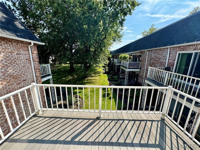 wooden terrace with a lawn