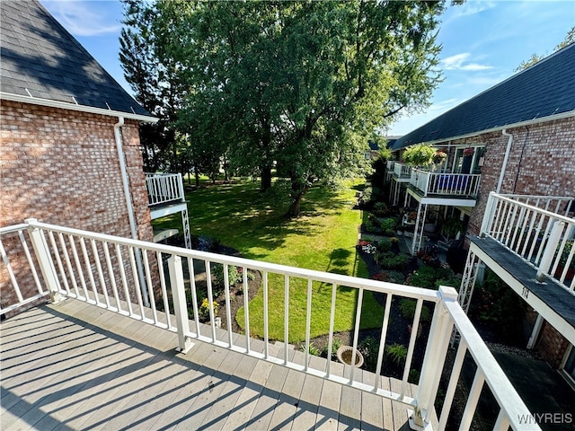 wooden deck featuring a yard