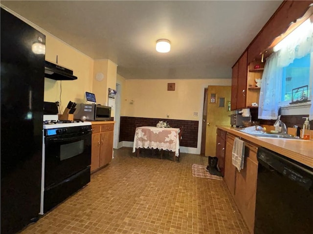 kitchen featuring light countertops, a sink, open shelves, under cabinet range hood, and black appliances