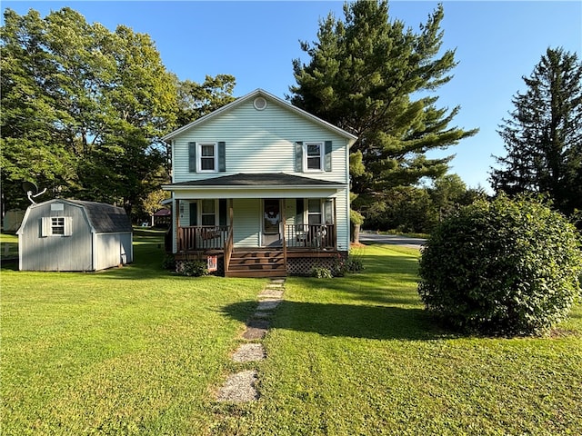 rear view of house with a storage shed, covered porch, and a lawn