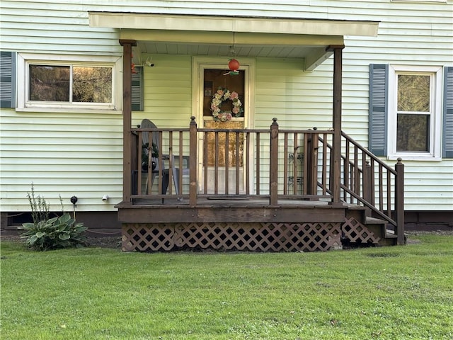 view of exterior entry with a yard