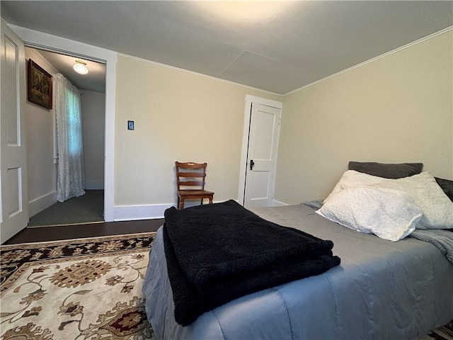 bedroom featuring ornamental molding and baseboards
