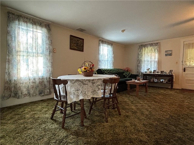 dining area featuring visible vents and carpet
