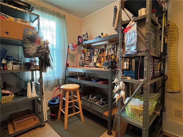 miscellaneous room featuring a workshop area, crown molding, and tile patterned floors