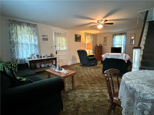 living area with carpet flooring, a ceiling fan, and baseboards