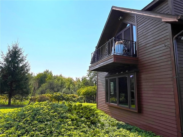 view of side of home with a balcony