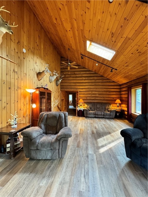 living room featuring high vaulted ceiling, a skylight, wood-type flooring, and wooden ceiling