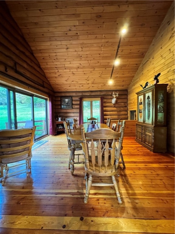 dining room with high vaulted ceiling, light hardwood / wood-style floors, and wooden ceiling