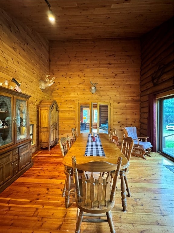 dining room with wooden ceiling and light hardwood / wood-style floors