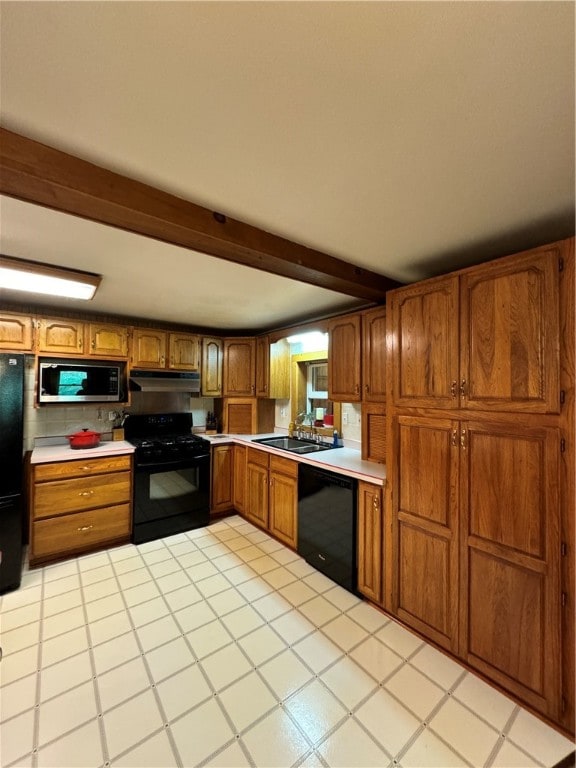 kitchen featuring black appliances, sink, light tile patterned floors, and beam ceiling