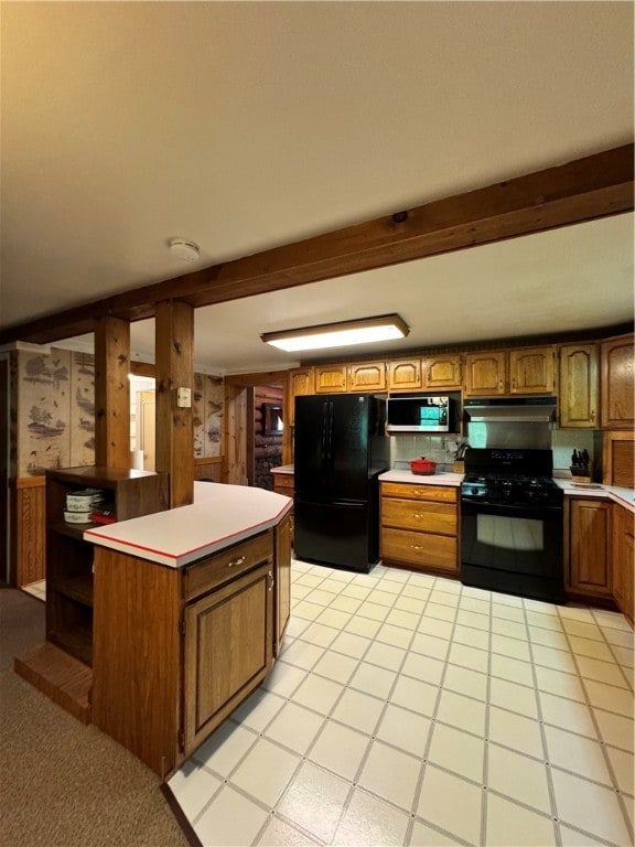 kitchen featuring black appliances, light tile patterned floors, and beam ceiling