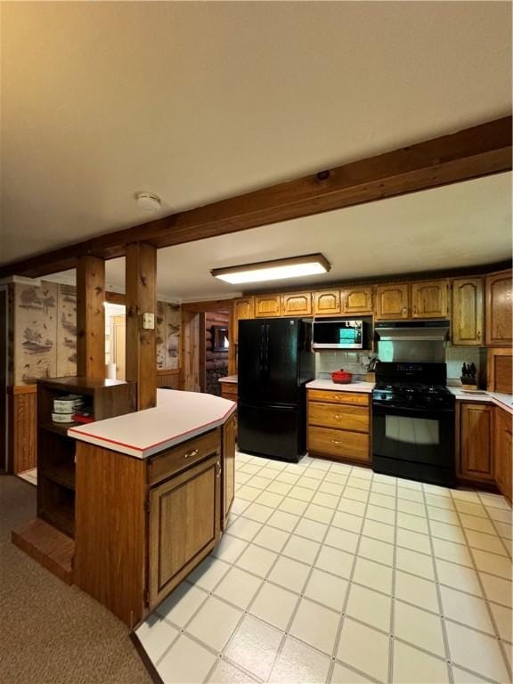 kitchen with a center island, beam ceiling, and black appliances