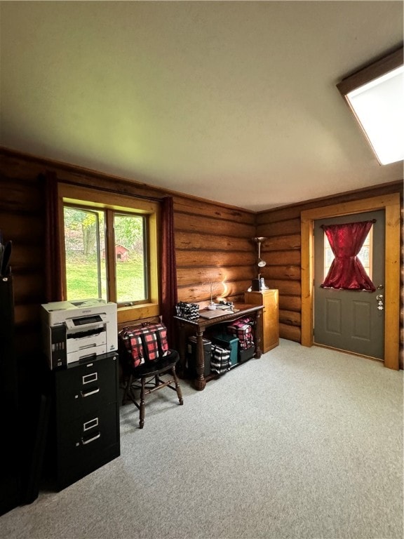 carpeted office space featuring rustic walls