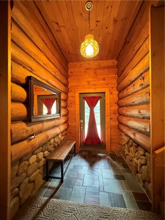 doorway with log walls and wooden ceiling