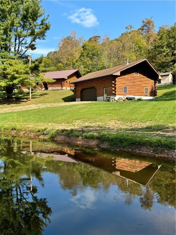 exterior space with a water view and a lawn