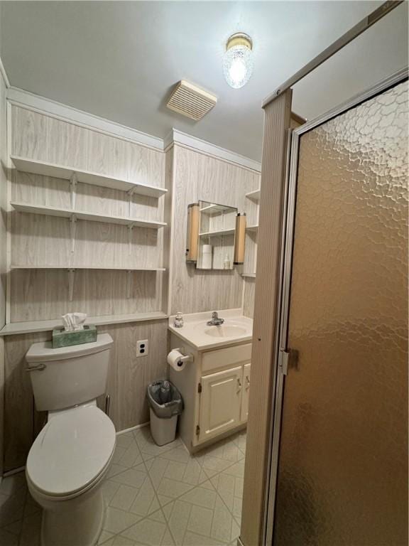 bathroom with wood walls, ornamental molding, vanity, walk in shower, and toilet