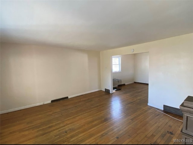 spare room featuring dark wood-type flooring