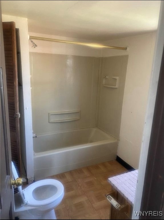 full bathroom with parquet floors, vanity, toilet, and washtub / shower combination