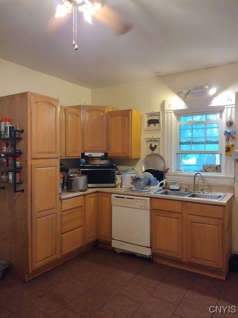 kitchen with ceiling fan, dark tile patterned flooring, sink, dishwasher, and light brown cabinetry