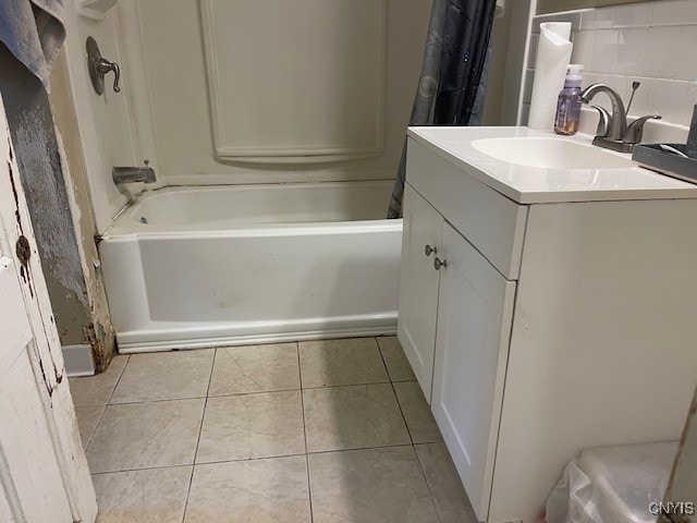 bathroom featuring vanity, tile patterned flooring, tasteful backsplash, and shower / bath combo