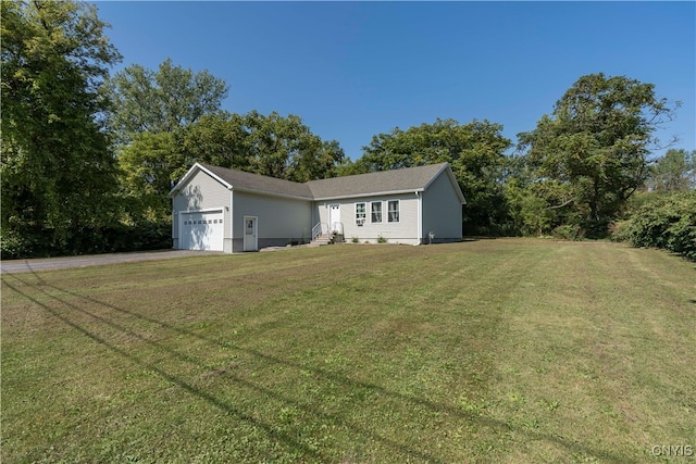 view of front of property with a front yard and a garage