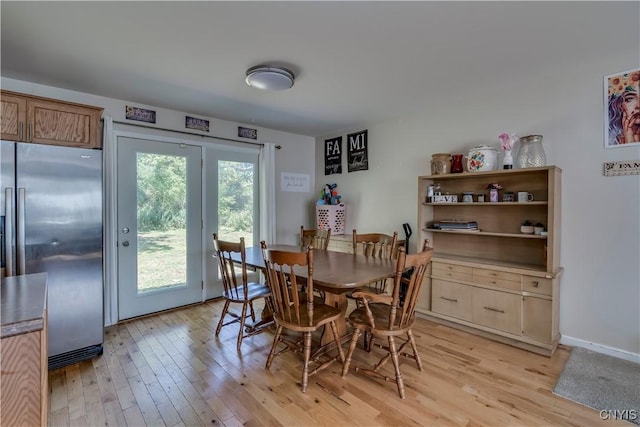 dining space featuring light wood-type flooring