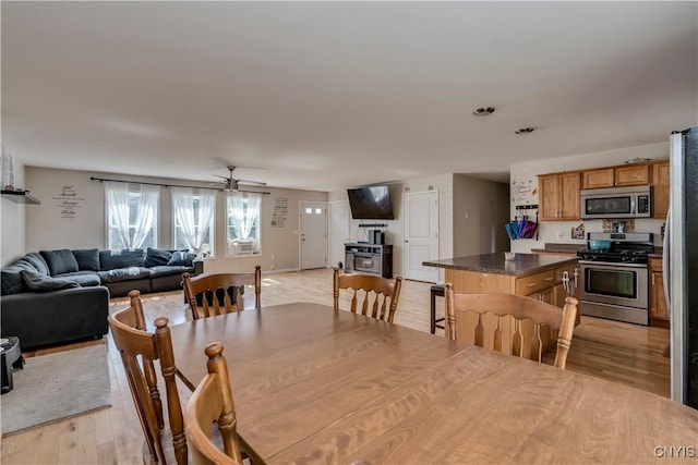 dining space featuring light hardwood / wood-style floors and ceiling fan