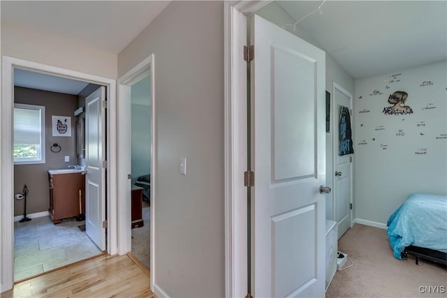 interior space with light hardwood / wood-style flooring and sink