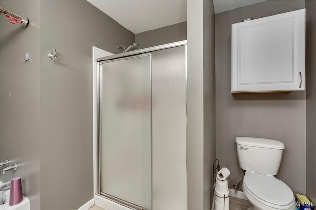 bathroom featuring toilet and walk in shower