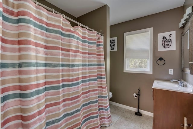 bathroom featuring tile patterned flooring, vanity, and toilet