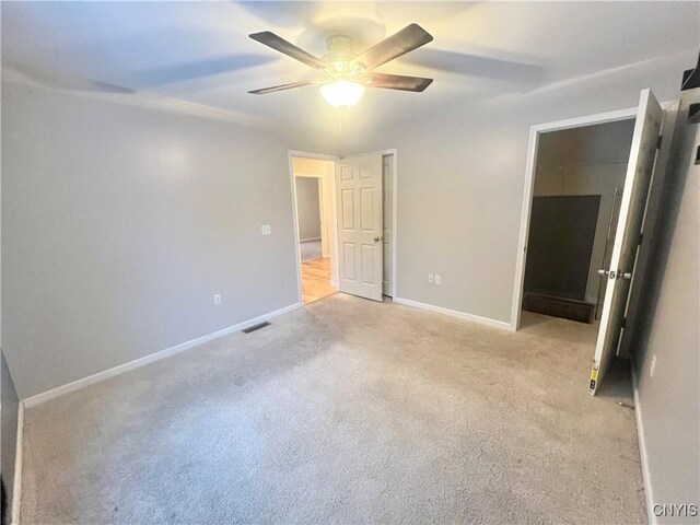 unfurnished bedroom featuring ceiling fan and light colored carpet