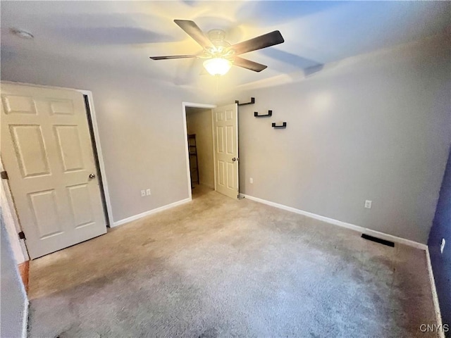 unfurnished bedroom featuring ceiling fan and light colored carpet