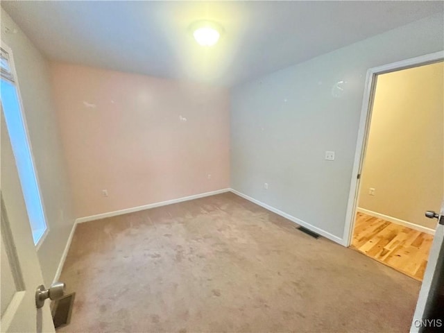 spare room with hardwood / wood-style flooring