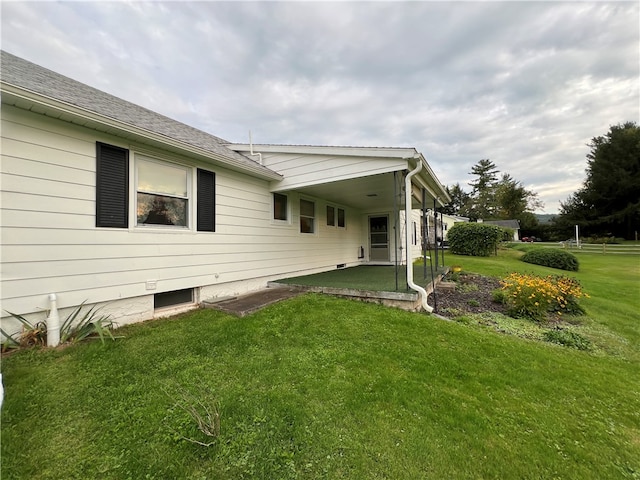 view of side of home featuring a lawn