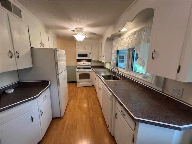 kitchen with white appliances, white cabinets, sink, ornamental molding, and light hardwood / wood-style floors