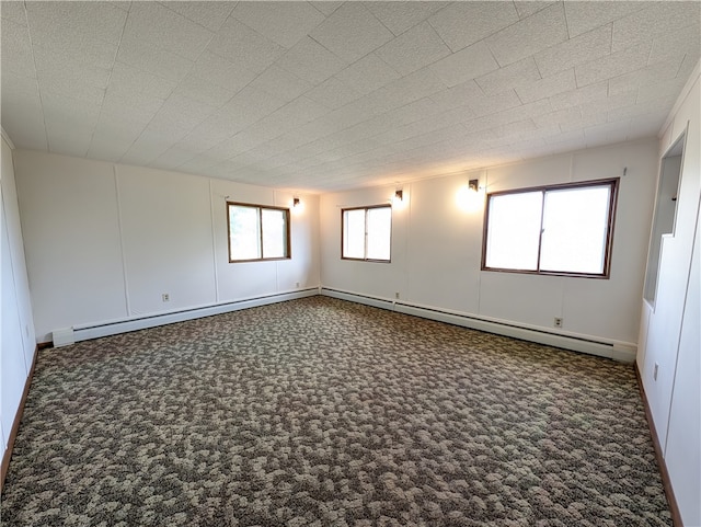 carpeted empty room with a textured ceiling and baseboard heating