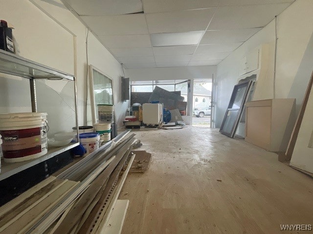 miscellaneous room with a drop ceiling and light hardwood / wood-style flooring