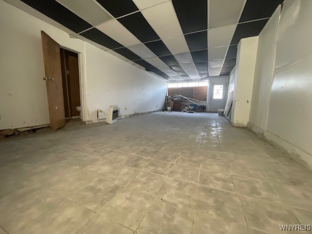 unfurnished room with a drop ceiling