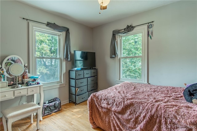 bedroom with light hardwood / wood-style flooring and ceiling fan