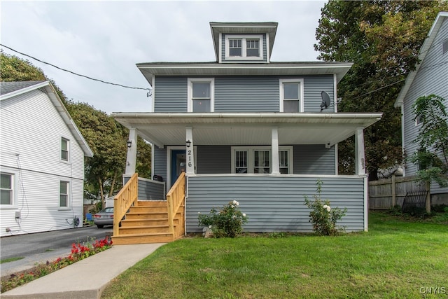 view of front of home with a front yard and covered porch