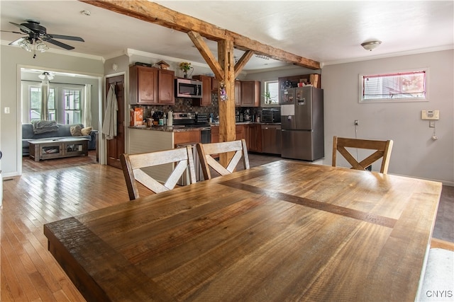 dining room with light hardwood / wood-style floors, ornamental molding, and ceiling fan